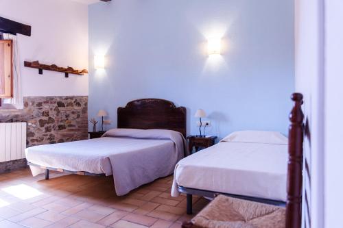 a bedroom with two beds in a room at Agroturisme Sant Dionis in Campllong