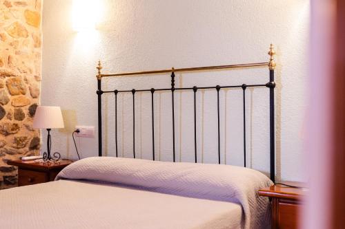 a bedroom with a bed and a lamp on a table at Agroturisme Sant Dionis in Campllong