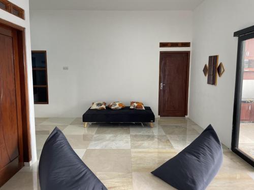 a room with a bed with pillows on it at Villa Madukoro Asri in Wonosobo