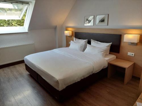 Postel nebo postele na pokoji v ubytování Taste Style Hotel Bären Auggen
