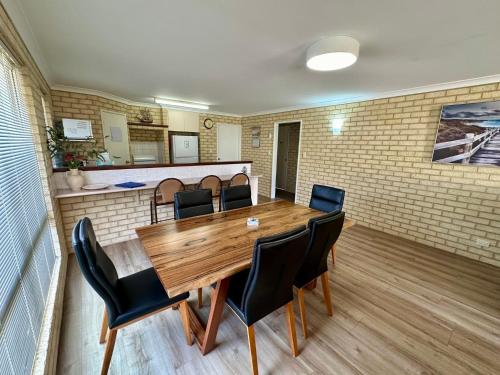 a conference room with a wooden table and chairs at Our Beach House- Busselton in Busselton