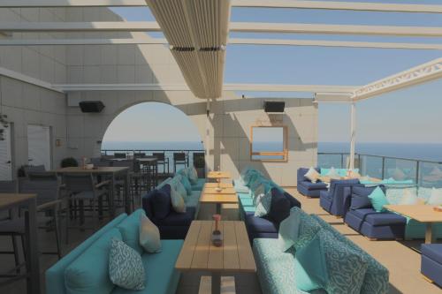 a rendering of a restaurant with blue couches and tables at Raouche Arjaan by Rotana in Beirut