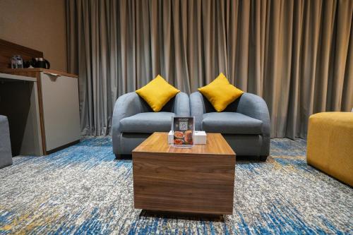 a living room with a couch and a coffee table at Almsakn Alola Hotel Company in Riyadh