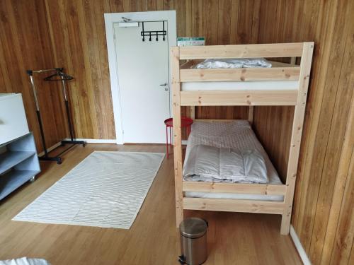 a bunk bed in a room with a door at Charlottsborgs Camping och Vandrarhem in Kristianstad