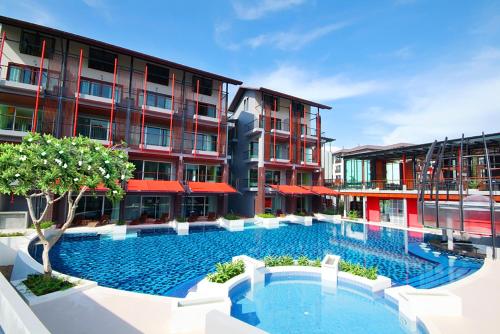 a large swimming pool in front of some buildings at Red Ginger Chic Resort in Ao Nang Beach
