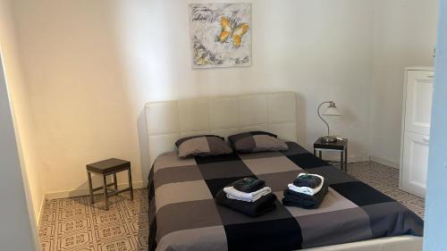 a bedroom with a bed with two bags on it at Dream Apartment Room lake 3 in Paradiso
