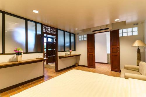 a living room with a bed and a couch at SKY - Fong Lee CC Lampang Walking Street in Lampang
