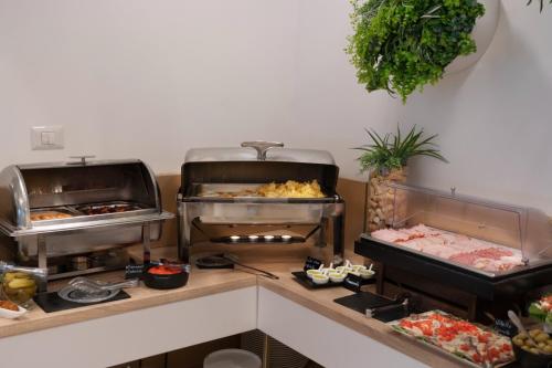 a buffet with many different types of food on display at Hotel Manor in Mamaia Nord