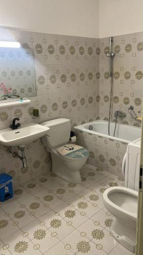 a bathroom with a toilet and a sink and a tub at Dreamapartment 4 Roomlake in Lugano