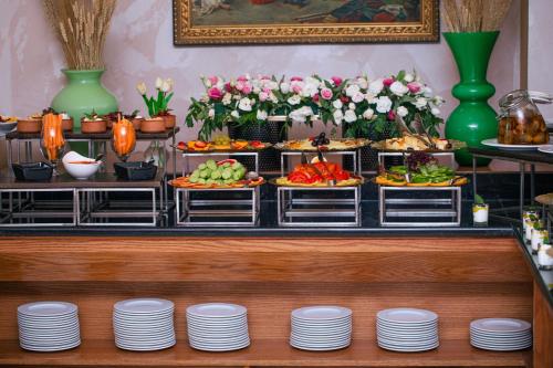 a buffet with plates and food on a table at Bristol Hotel in Amman