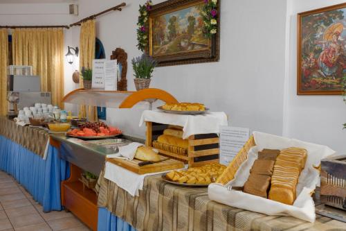 ein Buffet mit Brot und anderen Speisen auf dem Tisch in der Unterkunft Palm Bay by Estia in Sisi