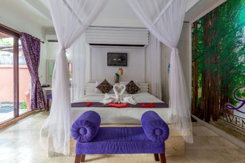 a bedroom with a large bed with purple chairs at Private Pool Villas in Kuta