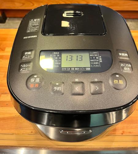 a calculator sitting on top of a wooden table at 貸切御宿 和 Nagomi in Utsunomiya