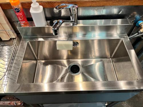 a stainless steel kitchen sink with a faucet at 貸切御宿 和 Nagomi in Utsunomiya