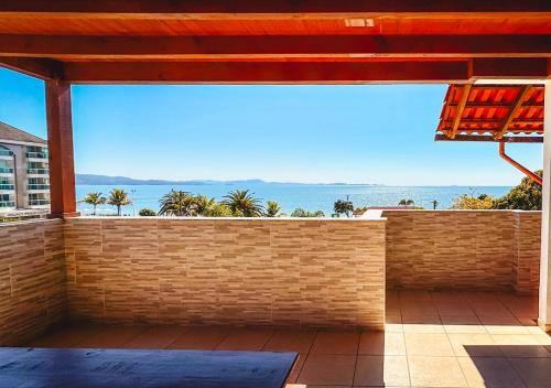 a view of the ocean from the balcony of a house at Pousada Vó Regina in Florianópolis