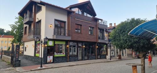 a group of buildings on a city street at Enika Hotel in Tryavna