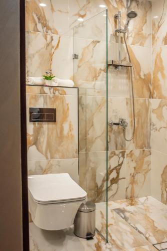 a bathroom with a toilet and a shower at Enika Hotel in Tryavna