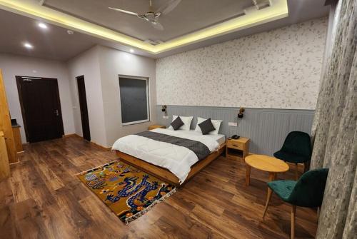 a bedroom with a bed and a table and chairs at The Clove Ladakh by LexStays in Leh