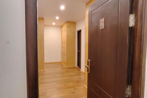 an empty room with a door and a hallway at The Clove Ladakh by LexStays in Leh