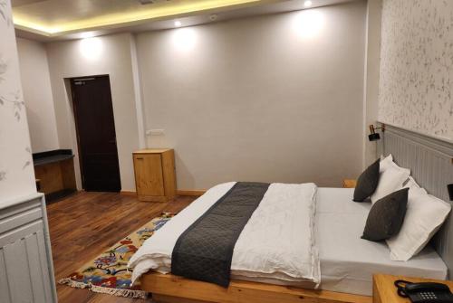 a bedroom with a large bed in a room at The Clove Ladakh by LexStays in Leh