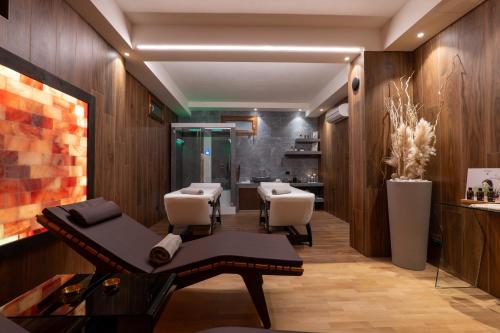 a salon with a bench and a table and chairs at Villasanpaolo Resort & Spa in San Gimignano