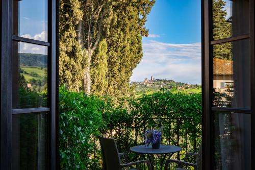 a window with a table and a view of a field at Villasanpaolo Resort & Spa in San Gimignano