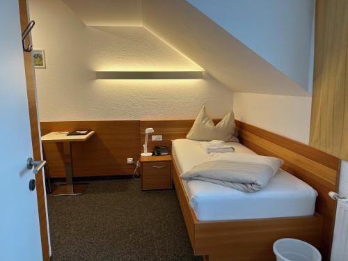 a small bedroom with a bed and a desk at Villa Styria in Bad Aussee