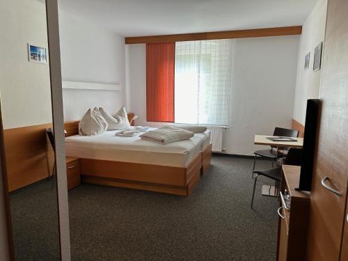 a hotel room with a bed and a window at Villa Styria in Bad Aussee