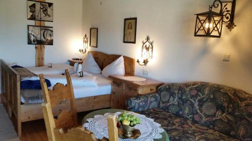 a living room with a bed and a couch at Alp Art Hotel Götzens in Innsbruck
