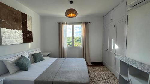 a bedroom with a large bed and a window at Port Chambly Riverfront in Terre Rouge