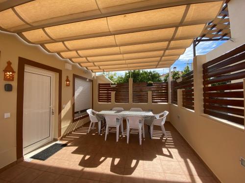 a patio with a table and chairs on it at Villa ELTAEL - Miguel House - Warm Pool until 1 November - Facilities for disabled guests in Manta Rota
