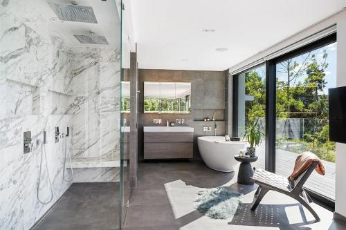 a bathroom with a tub and a sink at Lyxig villa i Solsidan in Stockholm