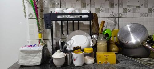 a kitchen counter with dishes and other kitchen utensils at One Bedroom Bamburi in Mombasa