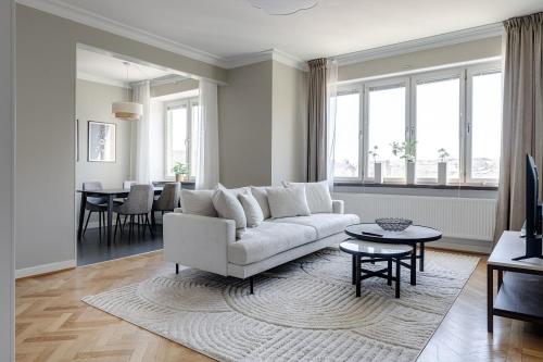 a living room with a white couch and a table at Live and Stay VR40 in Gothenburg