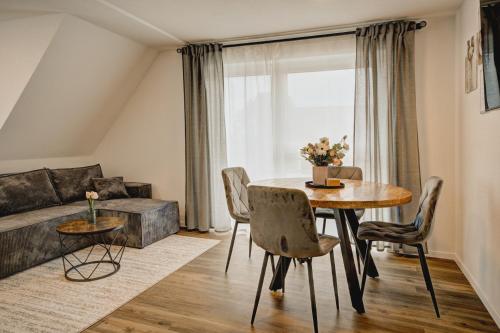 a living room with a table and a couch at MK Apartments in Aulendorf