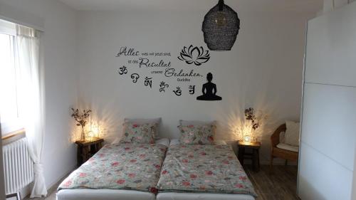 a bedroom with two beds and a clock on the wall at BBPrimavera in Purasca