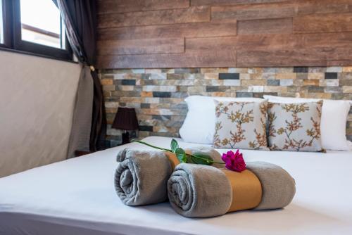 a hotel room with a bed with towels on it at Enika Hotel in Tryavna