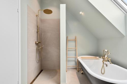 a bathroom with a ladder and a bath tub at Modern house by the Fjord in Sandane, Nordfjord. in Sandane