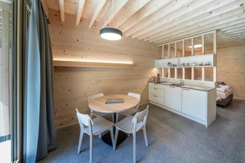a kitchen and dining room with a table and chairs at Apartment am Camping Dornbirn - 214 Staufen in Dornbirn