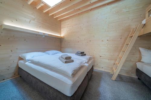 a wooden room with a bed and a ladder at Apartment am Camping Dornbirn - 214 Staufen in Dornbirn