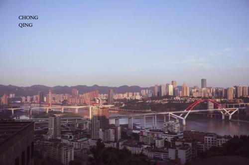 a city with a bridge over a river and buildings at Chongqing Desti Youth Park Hostel Liberation Monument in Chongqing