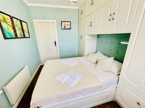 a bedroom with a bed with two towels on it at Positano in Varna City