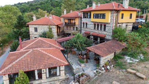 an aerial view of a large house with red roofs at Pliades Traditional Guesthouse in Palaios Panteleimon
