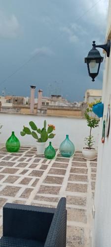 a group of green vases sitting on a patio at AREMU in Lecce