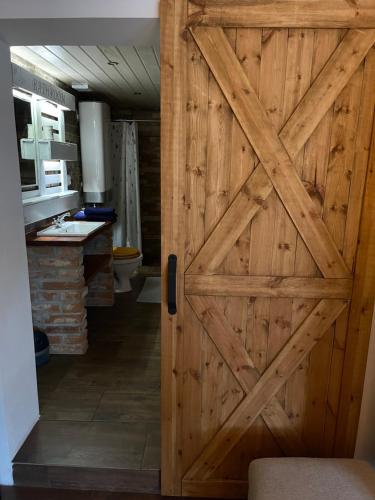 a wooden door in a room with a kitchen at Loft Apartments in Šluknov