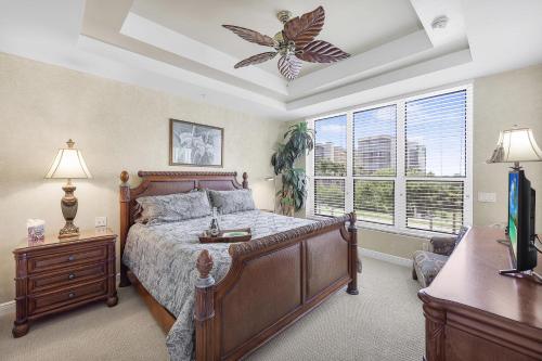 a bedroom with a large bed and a window at Peaceful condo with pool and steps to South Beach in Marco Island