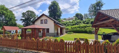 a wooden fence in front of a house at Lucie in Svitava