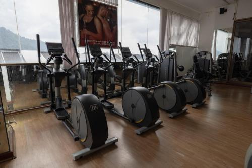 a gym with rows of exercise bikes in a room at Royal Phuket City Hotel in Phuket Town