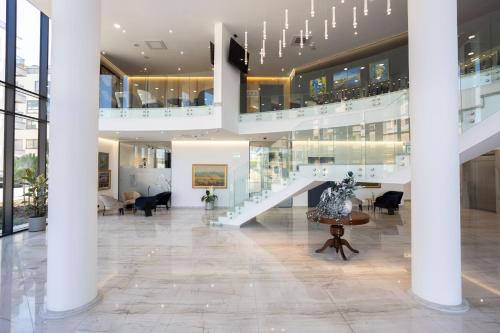 a lobby with a staircase in a building at Blue Star Luxury Hotel in Sofia