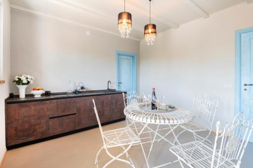 a kitchen with a table and chairs and a sink at ASILO in BAROLO - La Villa in Barolo